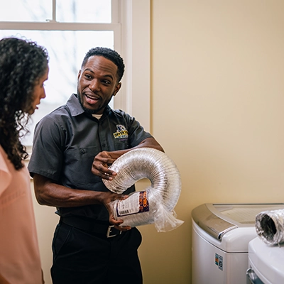 Technician showing customer a heating element.