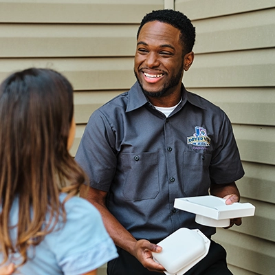 Technician smiling with customer.