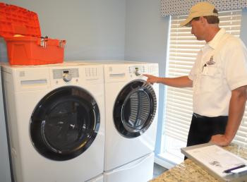 Technician pressing buttons on a dryer.