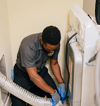 Dryer Vent Wizard technician servicing a dryer.