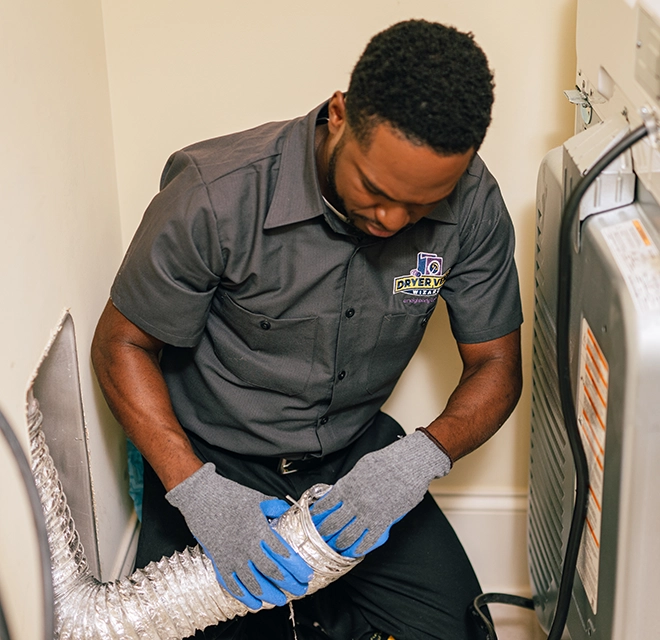 Technician wiping down a vent duct.