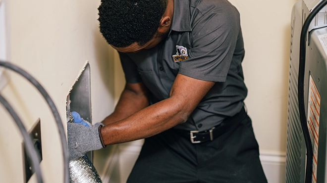 Technician installing vent duct.