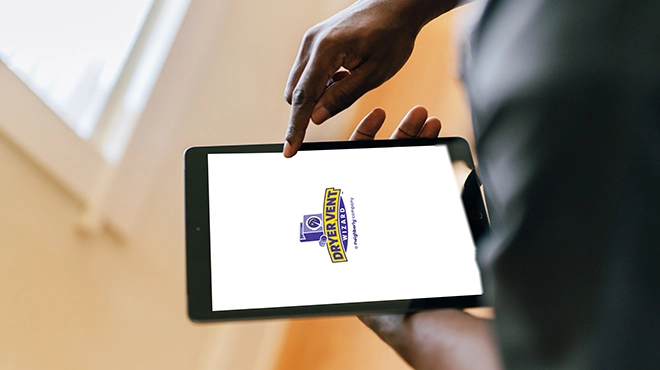Dryer Vent Wizard logo on tablet screen.