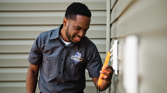 Technician measuring vent.