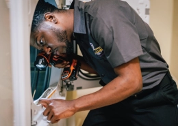 Dryer Vent Wizard professional peeking inside of dryer.