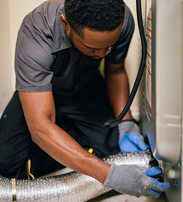 Technician working on dryer duct.