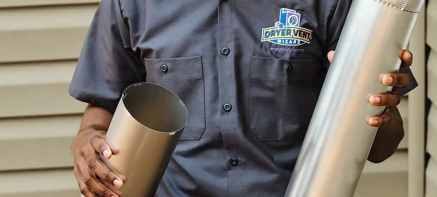 Technician holding dryer vent parts.