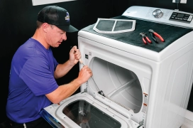 A professional from Dryer Vent Wizard cleans a residential dryer lint screen and lint trap.
