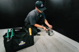 A residential dryer vent professional prepares a new dryer vent for installation in a home.