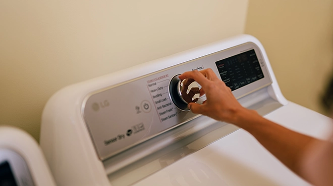 Customer turning on her dryer.