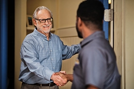 Dryer Vent Wizard tech shaking hands with customer.