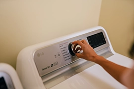 Hand turning dryer knob.