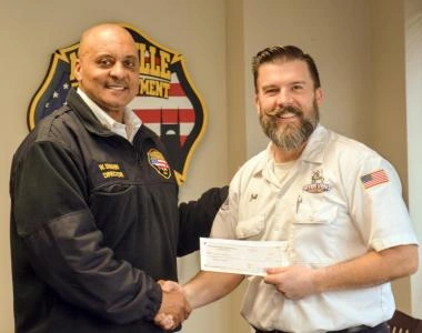 Dryer Vent Wizard awarding grant to Fire Department chief